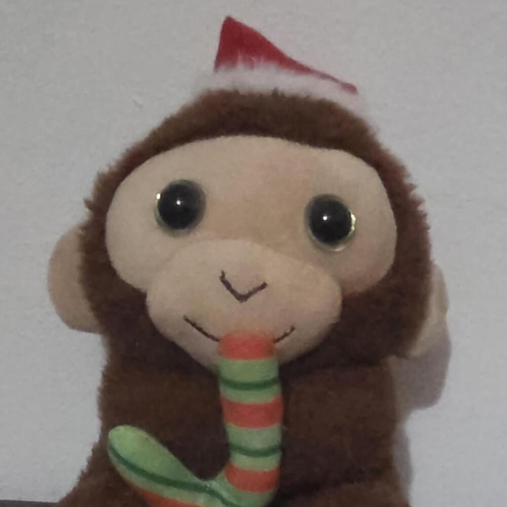 Brown plush monkey with red and green striped candy cane #christmas #holiday